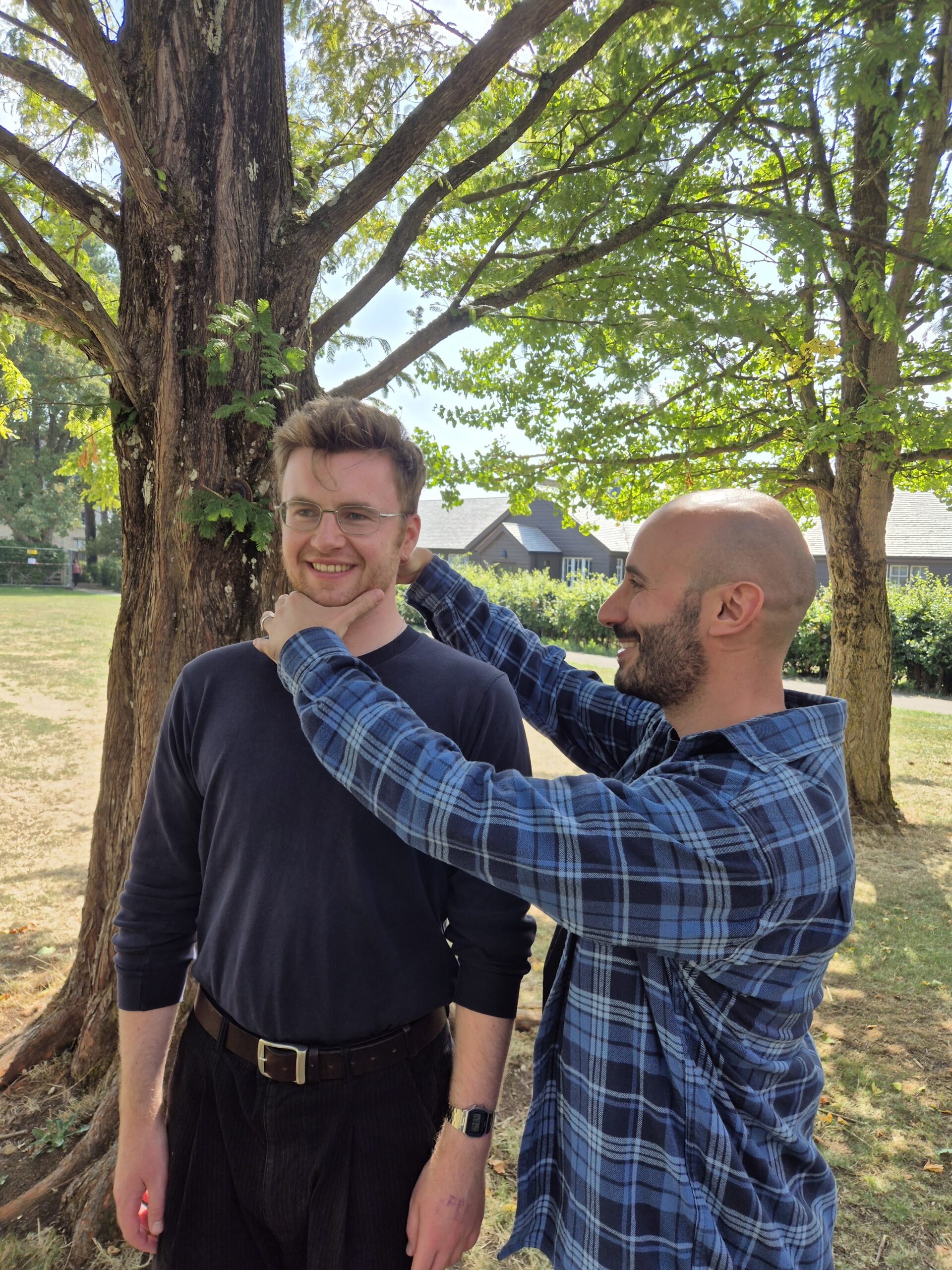 Simon teaching an Alexander Technique lesson, the student standing and smiling